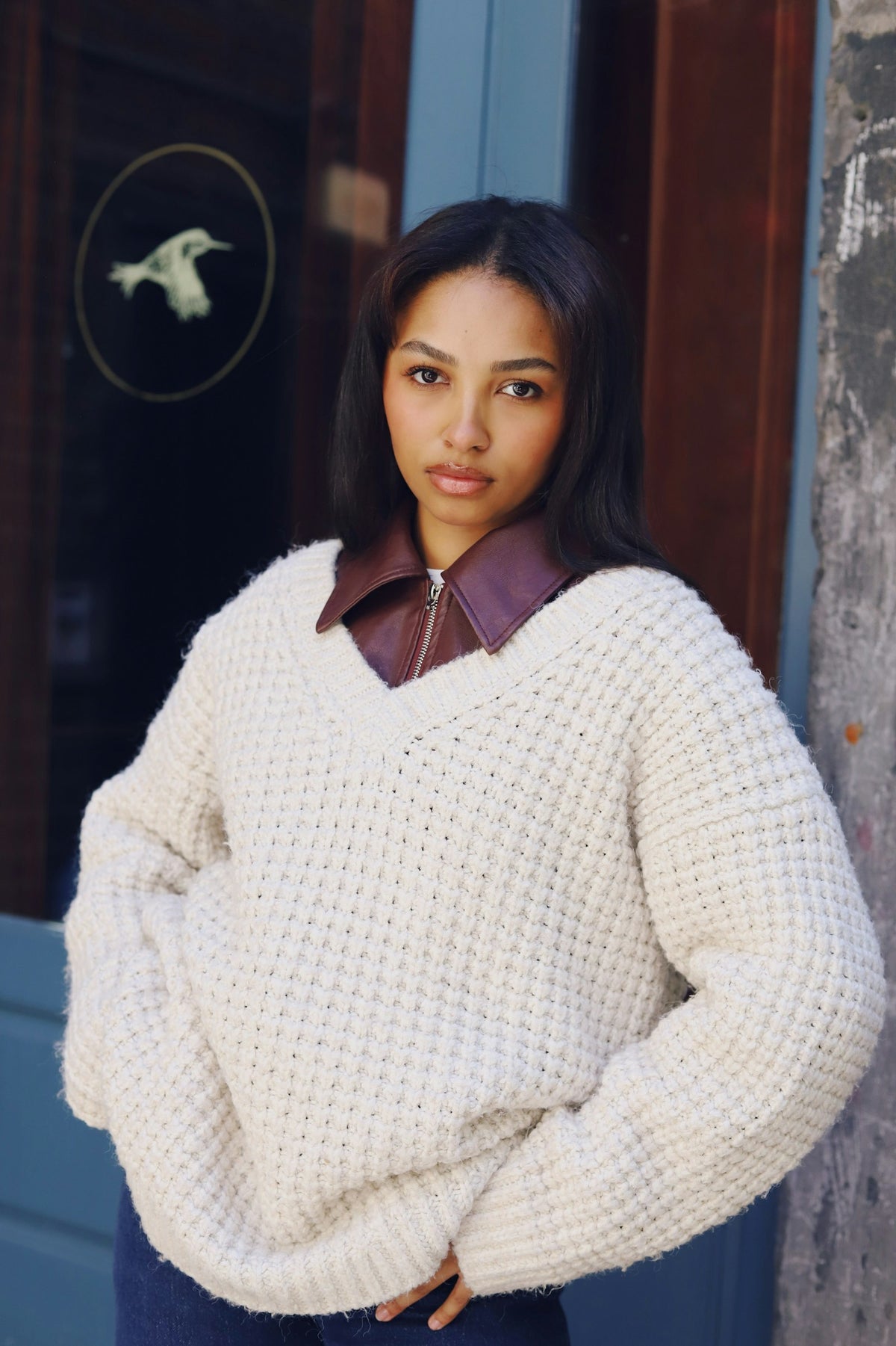 Woman in a cream chunky knit sweater